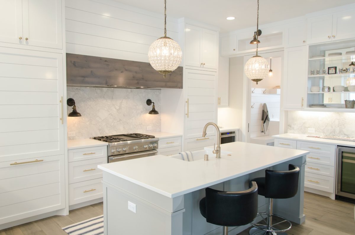 white kitchen with island and barstools