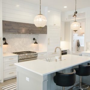 white kitchen with island and barstools