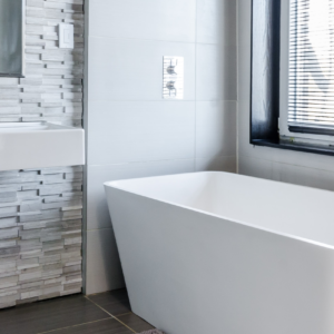 bathroom with tub under window