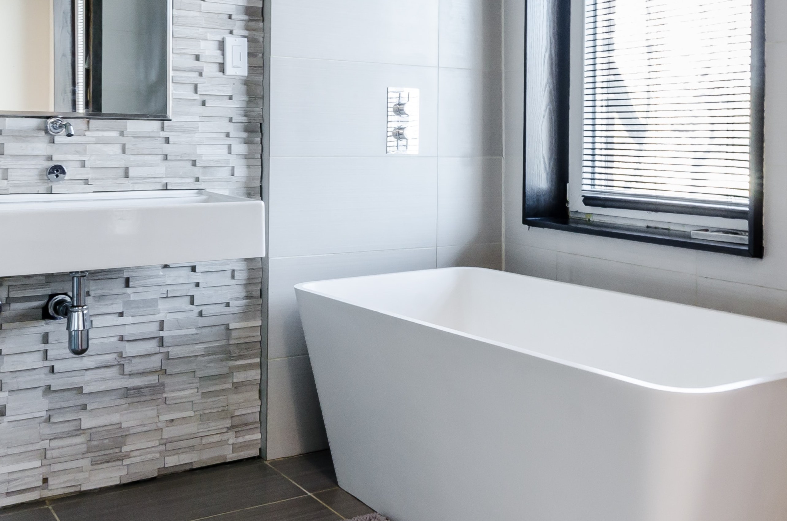 bathroom with tub under window